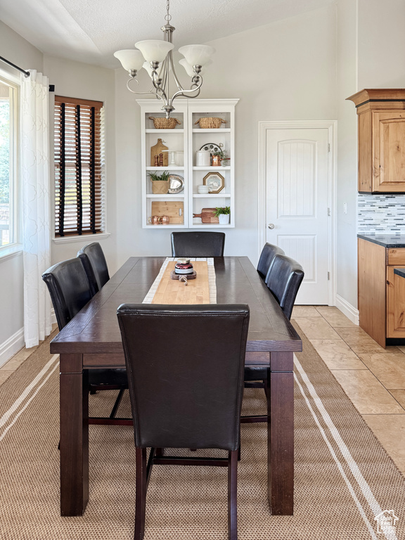 Dining area featuring a chandelier and light tile patterned floors