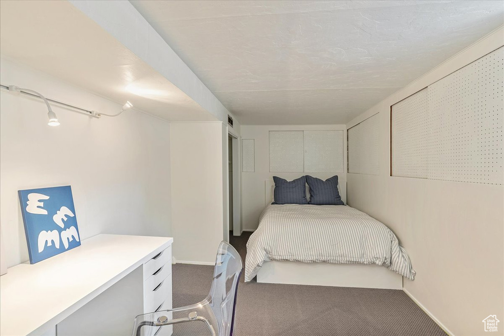 Carpeted bedroom featuring baseboards
