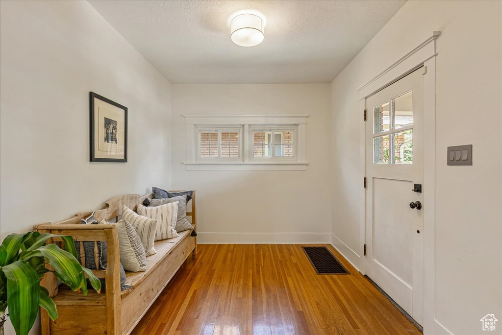 Entryway with wood finished floors and baseboards