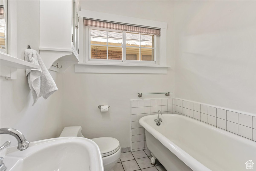 Full bathroom with a freestanding bath and tile patterned floors
