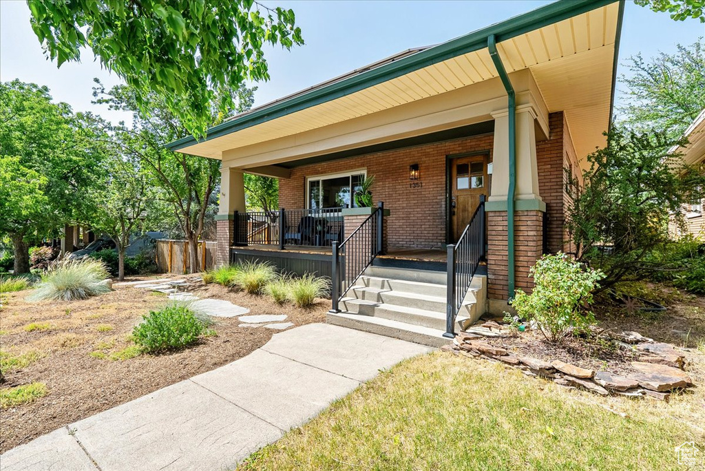 View of front of property featuring brick siding and a porch