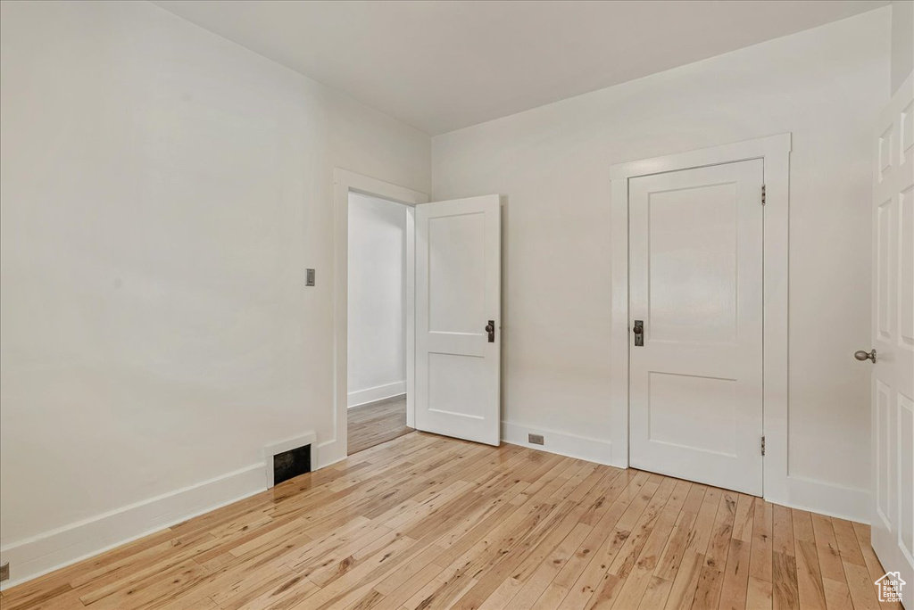 Unfurnished room with light wood-type flooring and baseboards