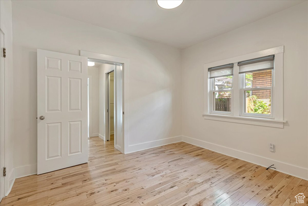 Spare room with light wood-style floors and baseboards