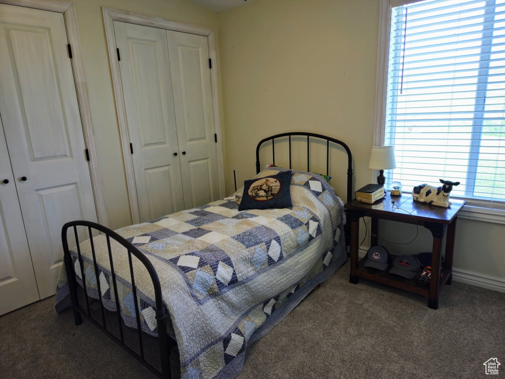 Carpeted bedroom with a closet