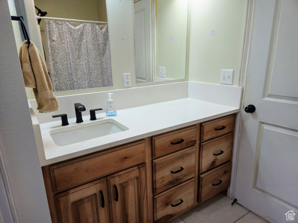 Full bathroom with vanity and tile patterned flooring