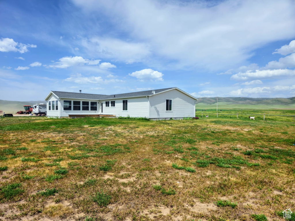 Rear view of property with a lawn and a view of rural / pastoral area