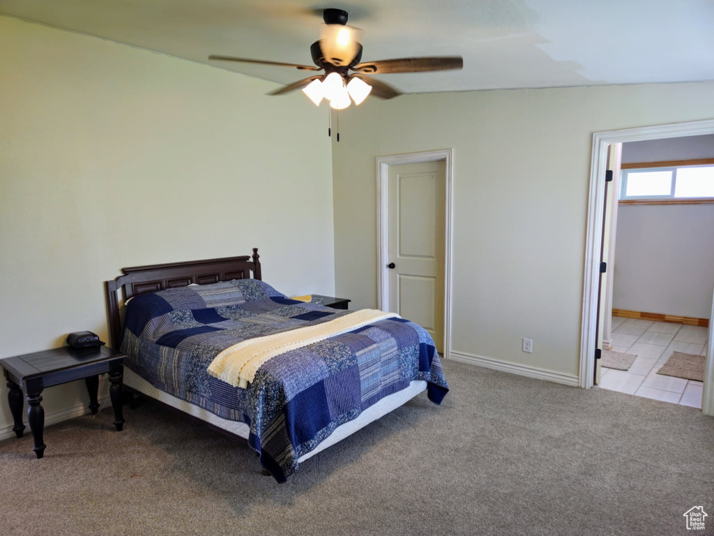 Carpeted bedroom featuring baseboards and ceiling fan