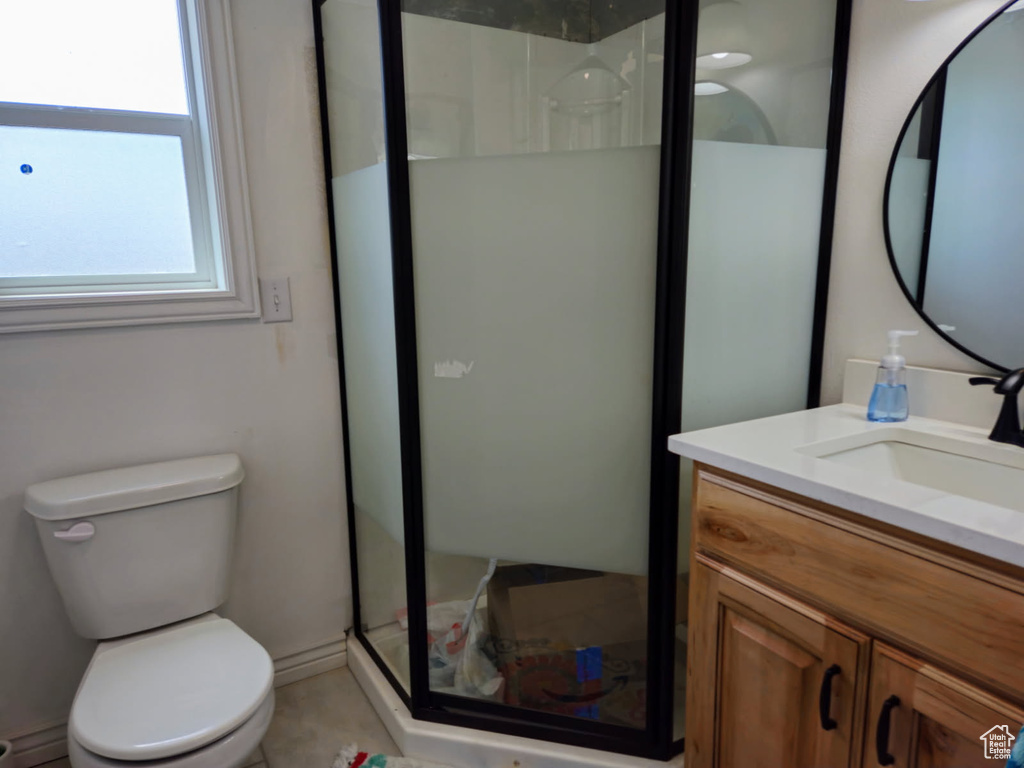 Bathroom featuring vanity and a stall shower