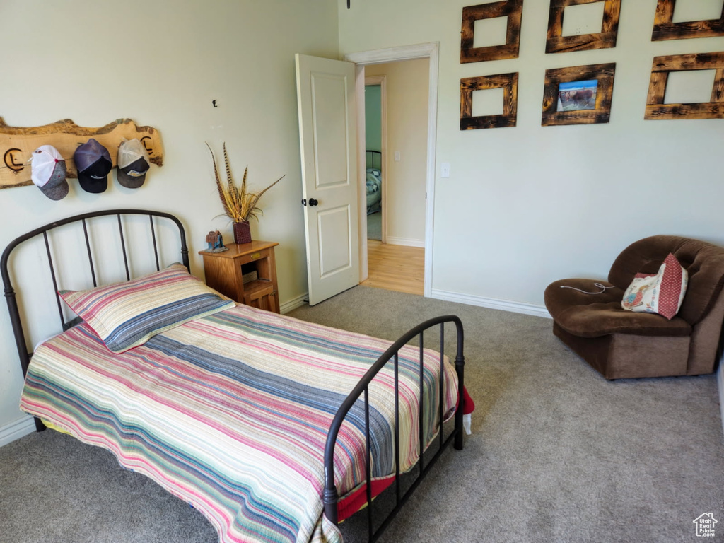 Bedroom with carpet flooring and baseboards