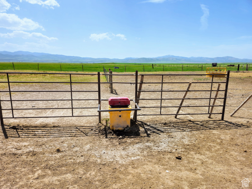 View of yard with a rural view and a mountain view