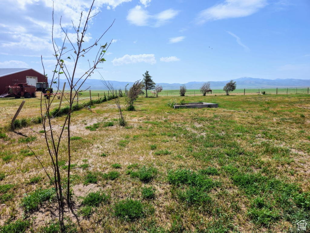 View of yard with a view of countryside, a mountain view, and a garage