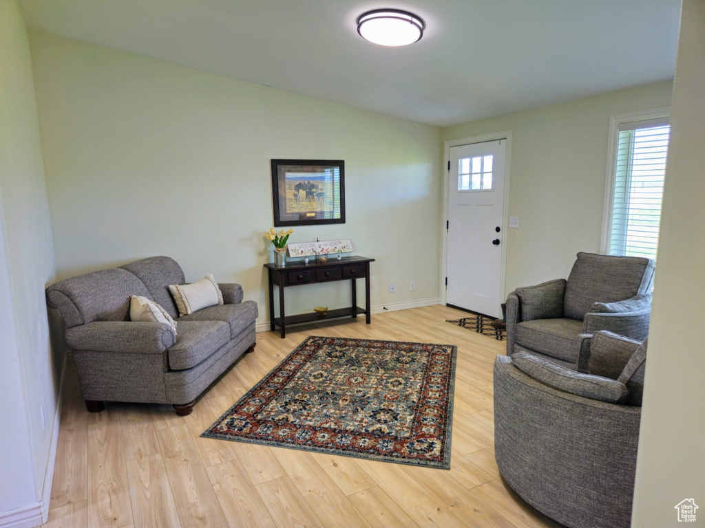 Living area with wood finished floors and vaulted ceiling
