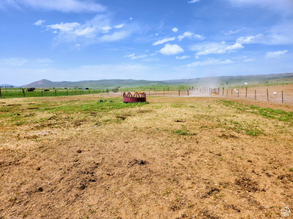 View of yard with a rural view and a mountain view