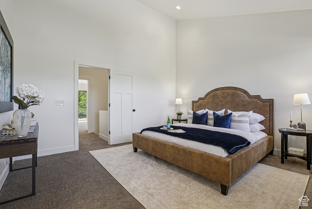 Bedroom featuring carpet floors, a high ceiling, and recessed lighting