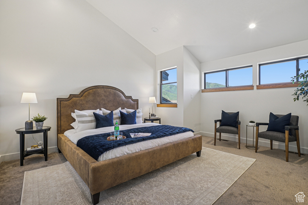 Carpeted bedroom featuring high vaulted ceiling and recessed lighting