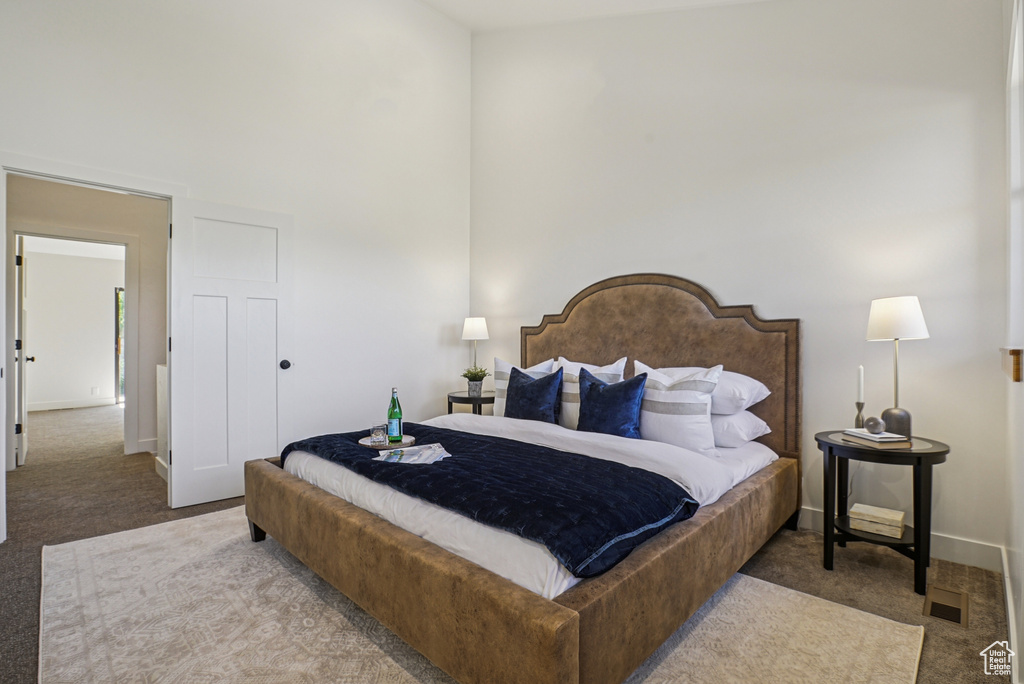 Bedroom with carpet and a towering ceiling