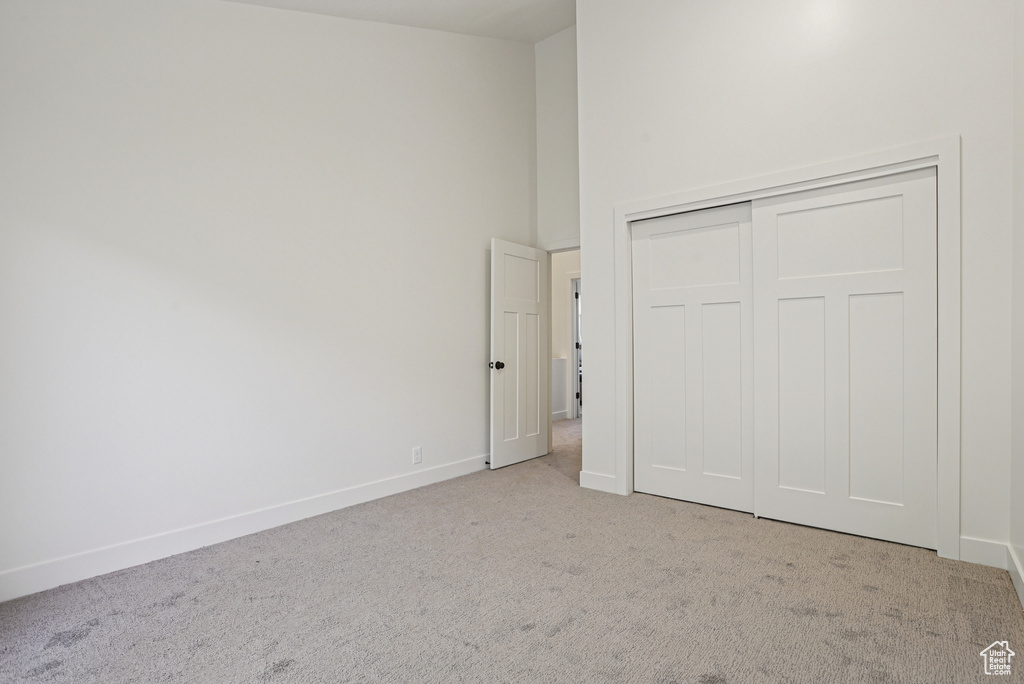 Unfurnished bedroom with carpet floors and a closet