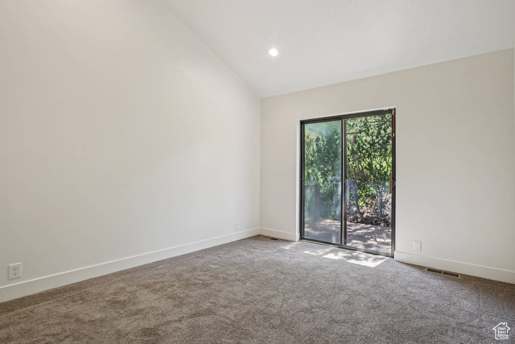 Carpeted empty room featuring recessed lighting and high vaulted ceiling