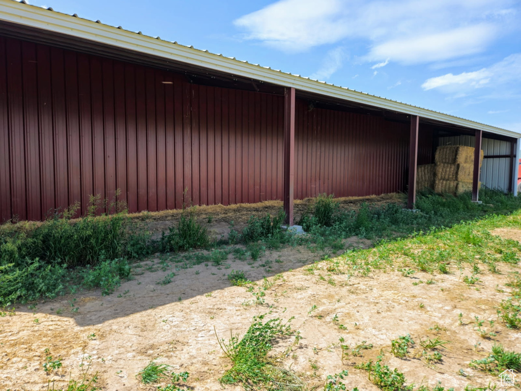 View of home's exterior with a pole building, an outbuilding, and a metal roof