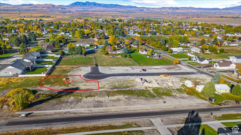Aerial view of residential area with mountains and property parcel outlined