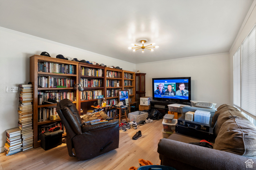Living area featuring a chandelier, wood finished floors, and ornamental molding