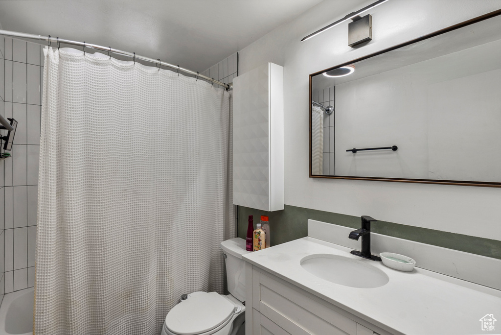 Full bath featuring vanity and shower / bath combo
