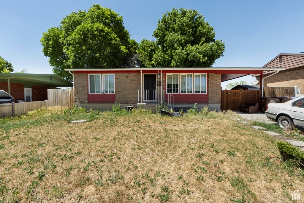 Ranch-style house with brick siding