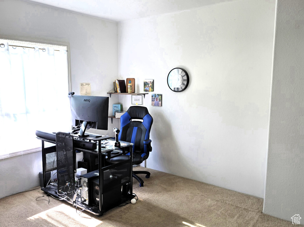 Office area featuring carpet floors and a textured ceiling