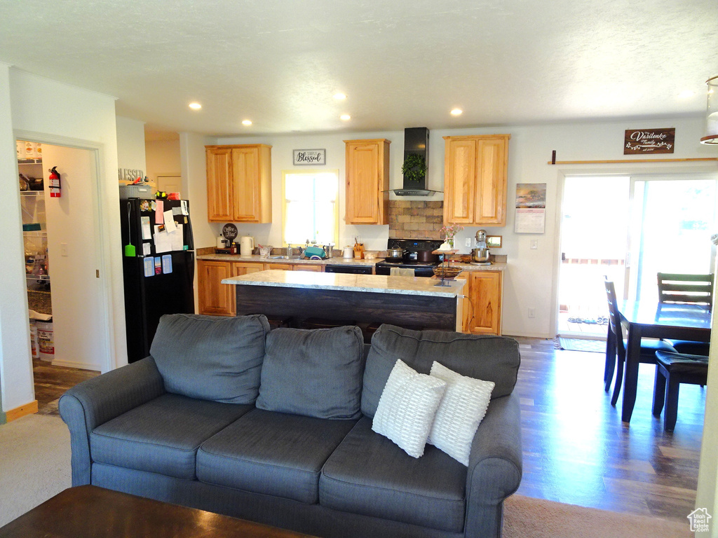 Living area featuring healthy amount of natural light, recessed lighting, and wood finished floors