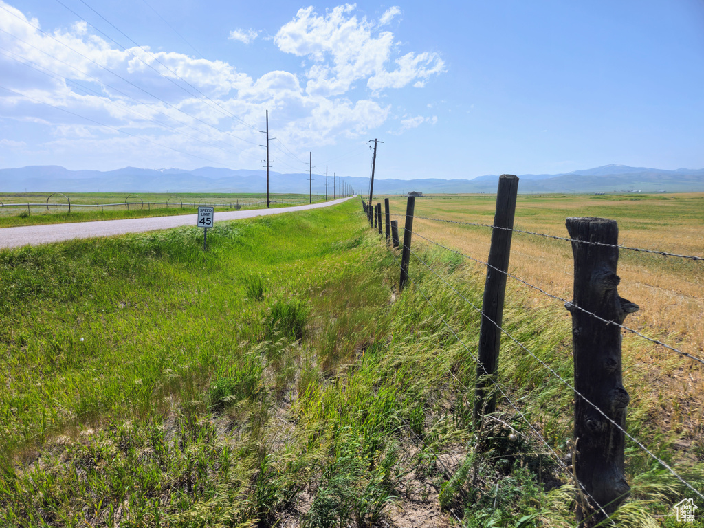 View of mountain backdrop with rural landscape and agricultural land