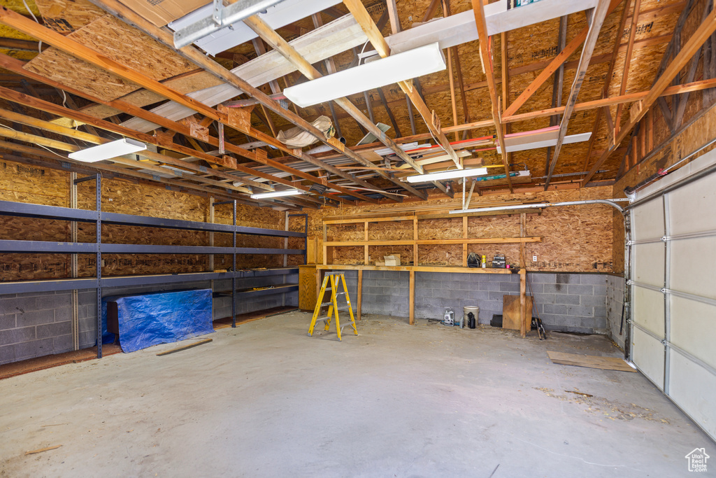 Garage featuring concrete block wall