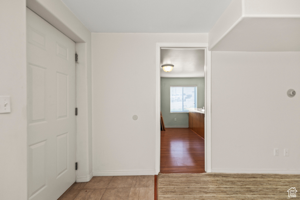 Empty room with baseboards and tile patterned flooring