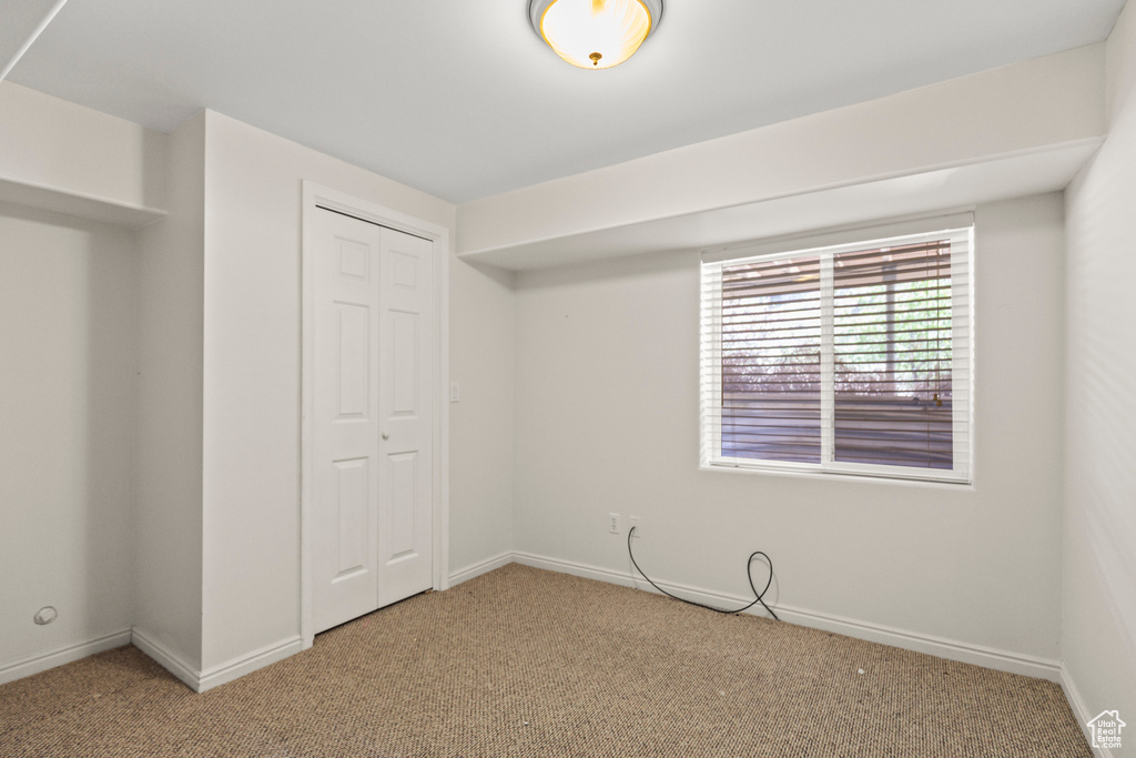 Unfurnished bedroom with carpet floors and a closet