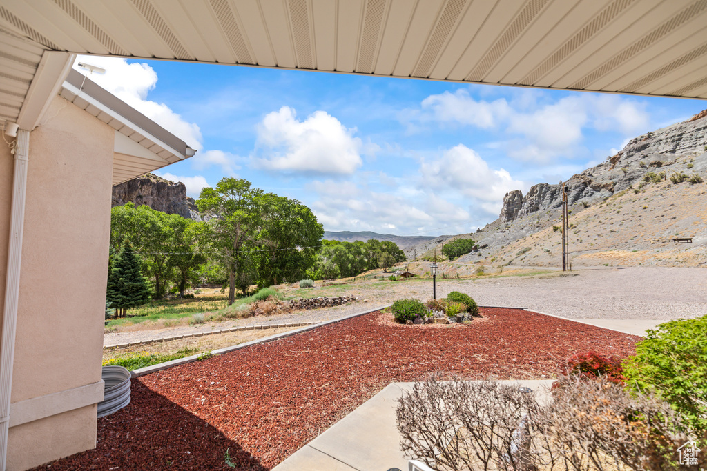 View of yard with a mountain view and a patio