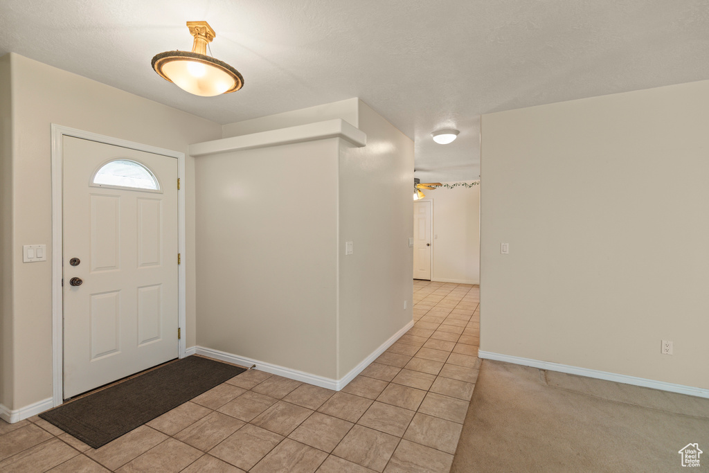 Entryway featuring light tile patterned floors and baseboards