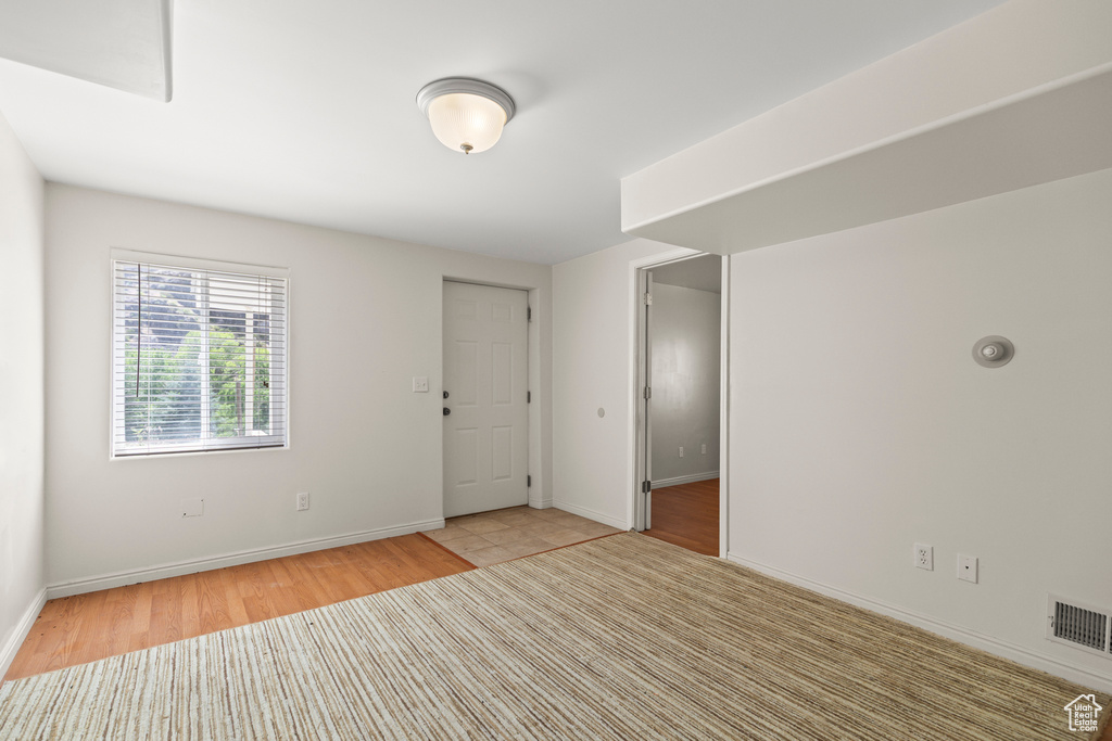 Unfurnished room with light wood-type flooring and baseboards