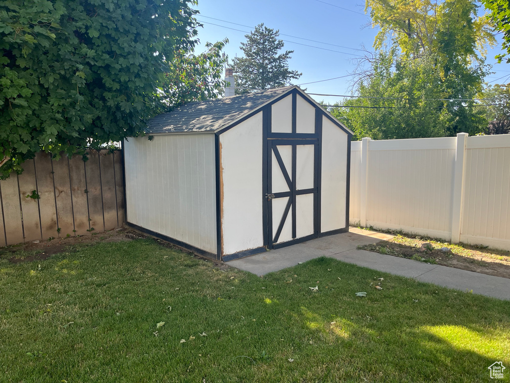 View of shed with a fenced backyard