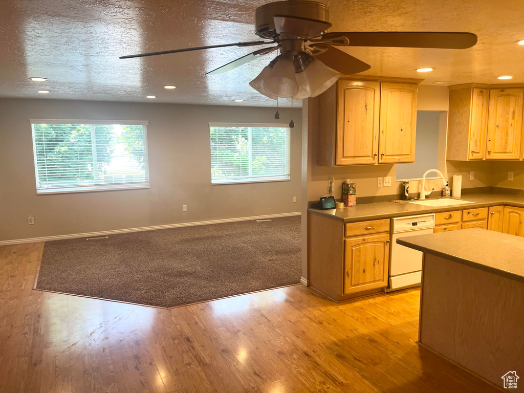 Kitchen with dishwasher, a ceiling fan, open floor plan, light wood-style flooring, and recessed lighting