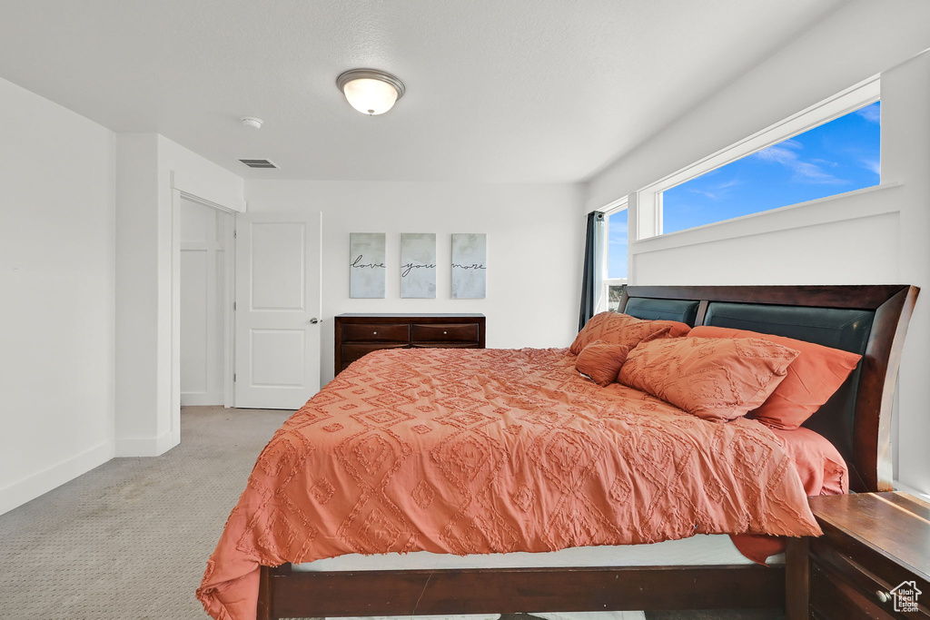 Bedroom with carpet floors and baseboards