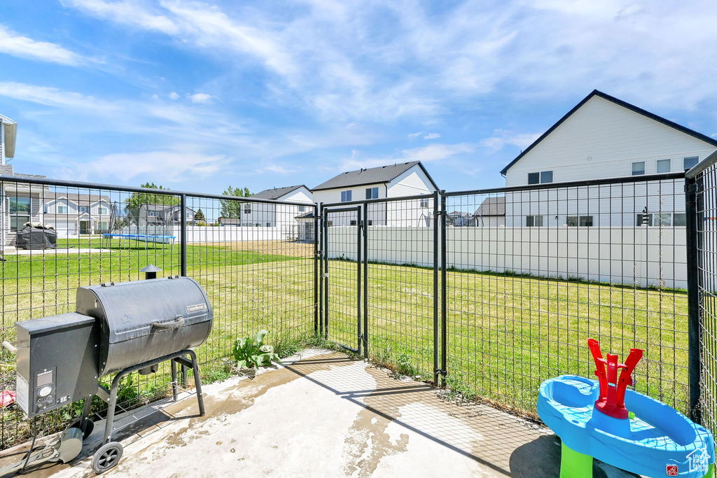 View of patio / terrace featuring a gate, grilling area, and a residential view