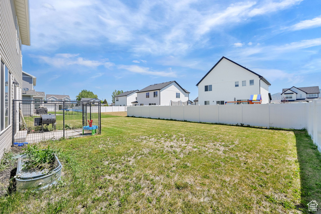 Fenced backyard with a residential view