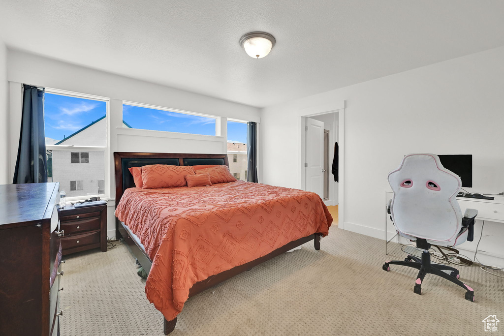 Bedroom with light carpet and baseboards