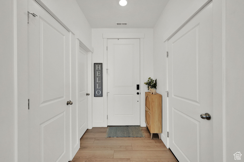 Doorway to outside with light wood-type flooring