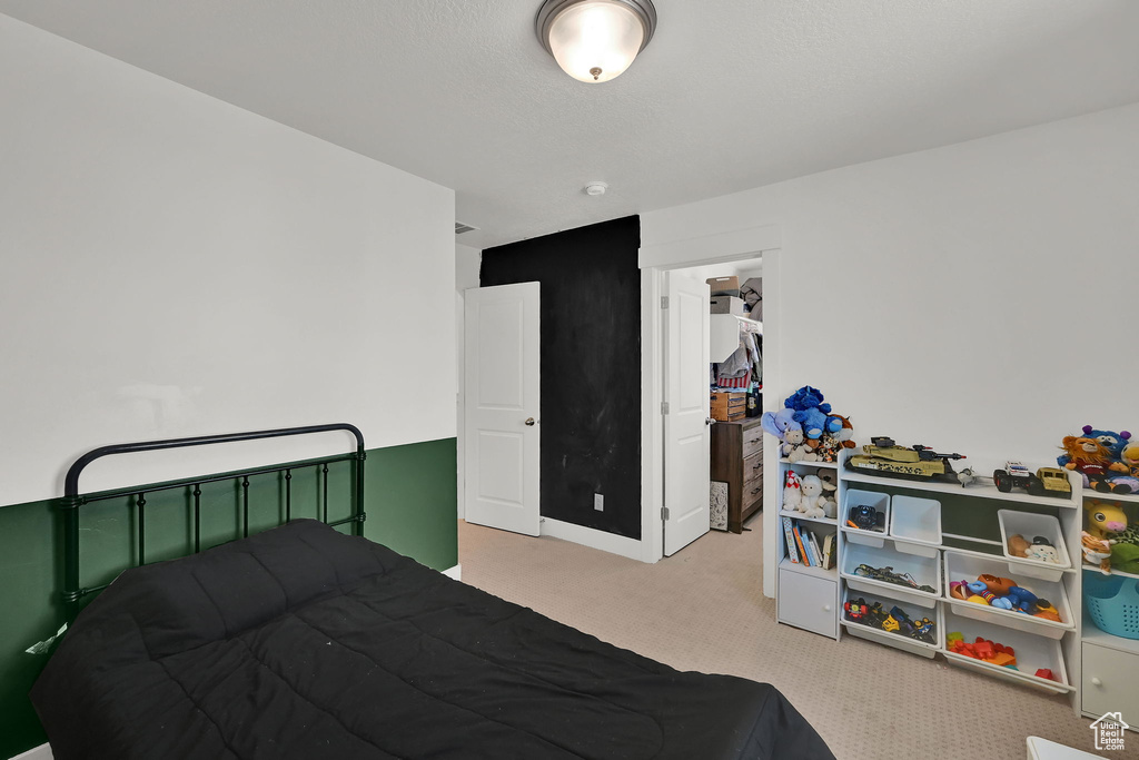 Bedroom with carpet floors and a spacious closet