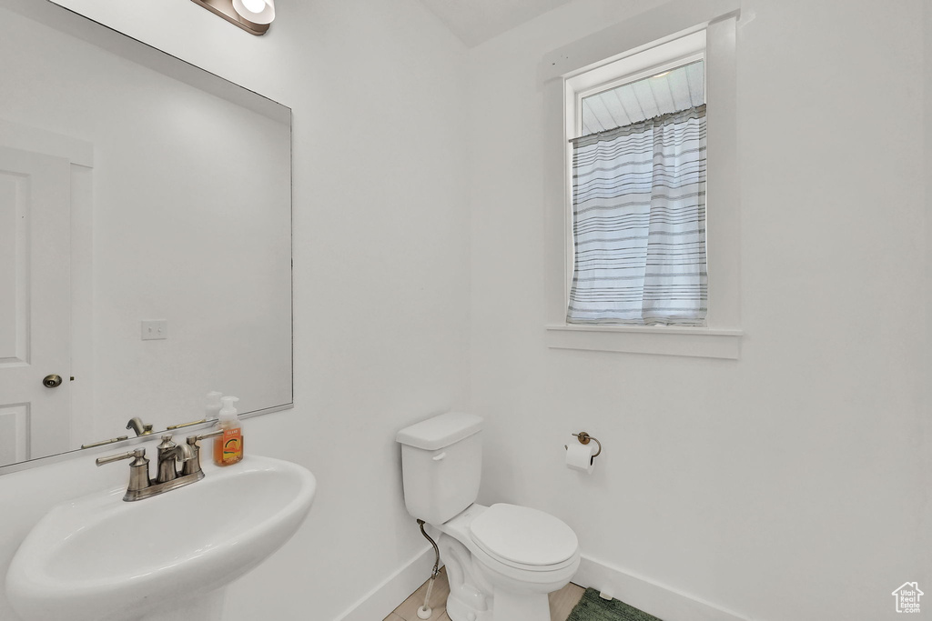 Bathroom with a sink and baseboards