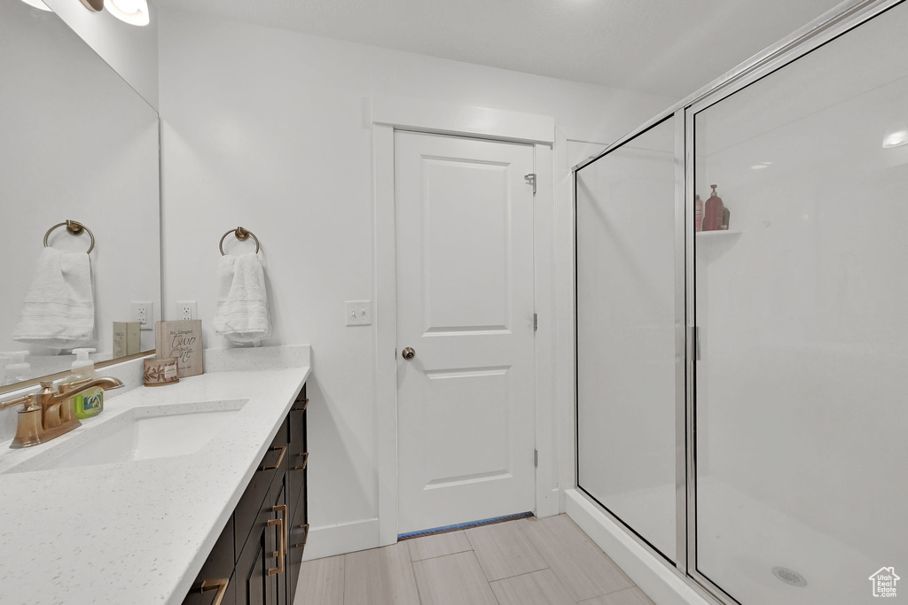 Full bath with vanity and a stall shower