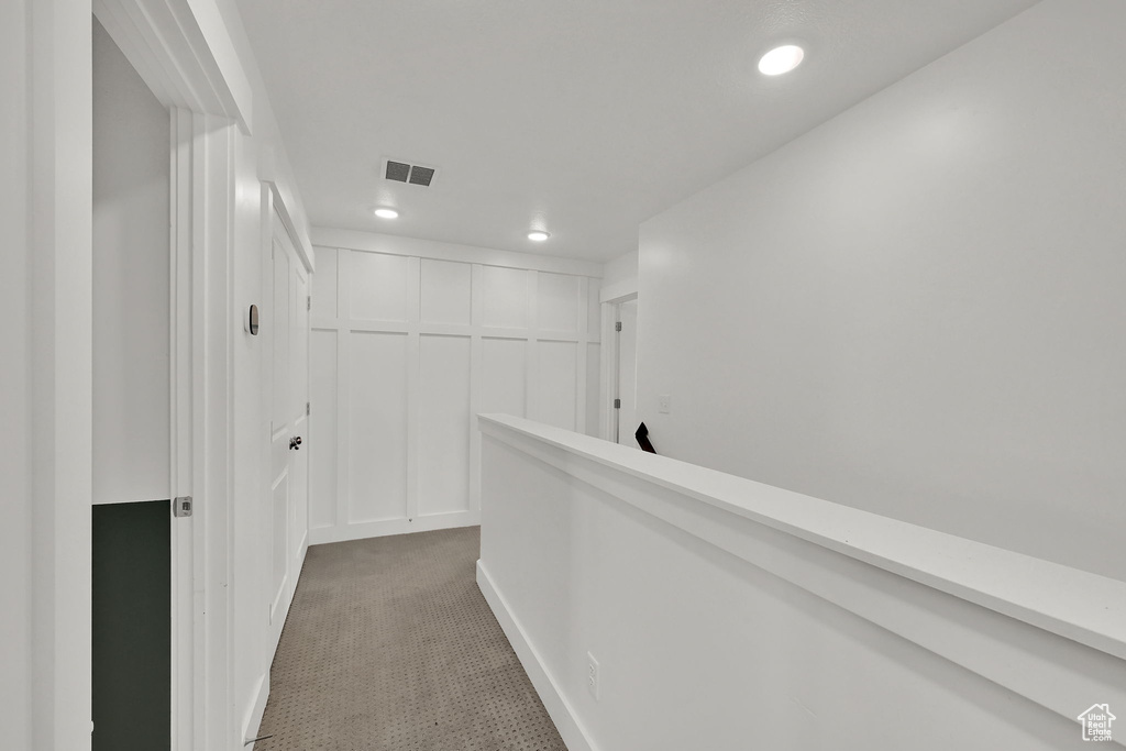 Corridor with recessed lighting and carpet flooring