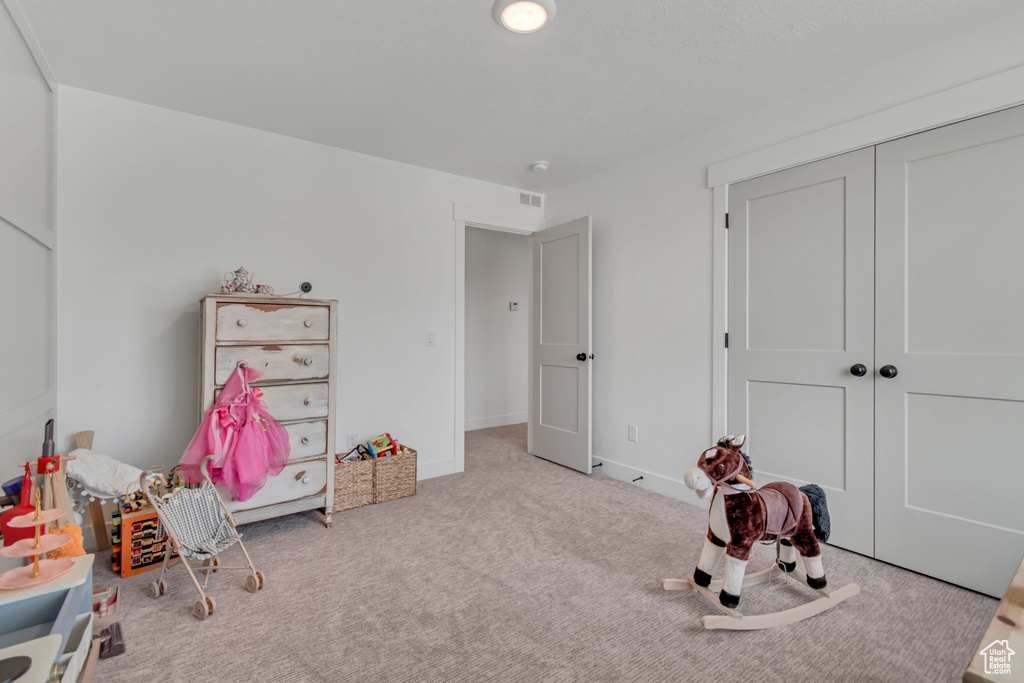 Rec room featuring carpet floors and baseboards