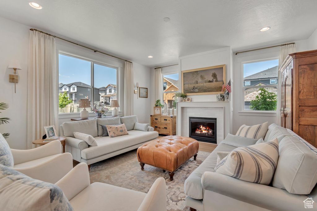 Living room with a warm lit fireplace and recessed lighting