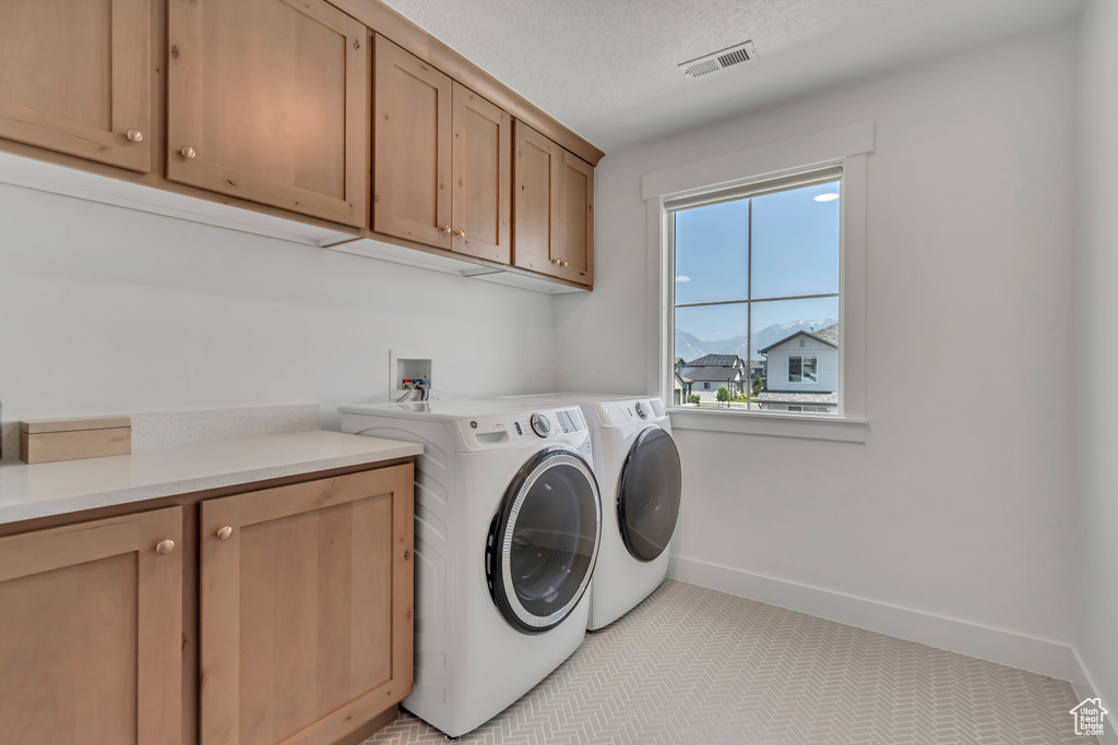 Laundry room with cabinet space and washing machine and clothes dryer